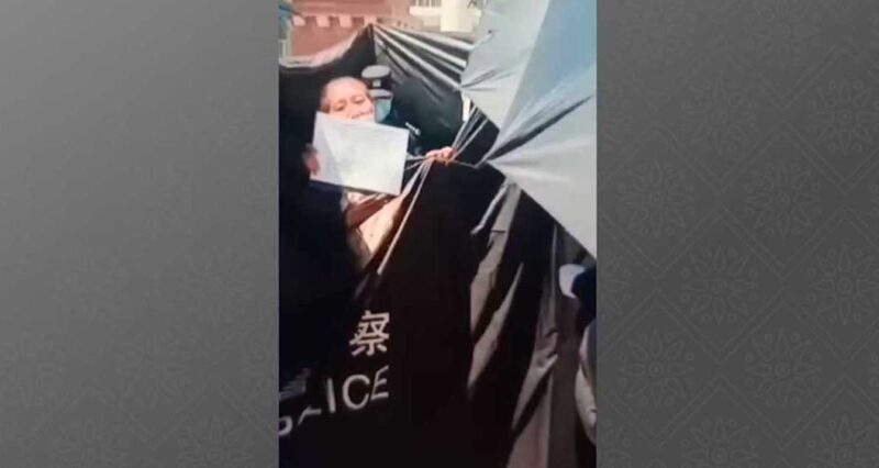 Police use banner to hide protest by imprisoned Tibetan’s sister
