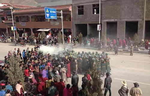 Troops are seen closing in on Dorje Rinchen's body after he has self-immolated. 